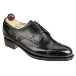 Angle view of men’s black Alt Wien Derby shoe on P2 last with a single sole – handmade by Vass Shoes.