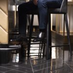 Side view-3 of men's black calf leather cap toe Oxford shoe on F last on a bar background - handmade by Vass Shoes.