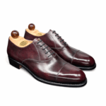 Angle view of men’s bordeaux museum calf leather cap toe Oxford shoe on F last with a single leather sole – handmade by Vass Shoes.