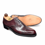 Side view of men’s bordeaux museum calf leather cap toe Oxford shoe on F last with a single sole – handmade by Vass Shoes.