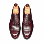 Top view of men’s bordeaux museum calf leather cap toe Oxford shoe on F last with a single leather sole – handmade by Vass Shoes.