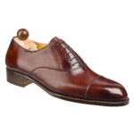 Angle view of men’s gold museum calf leather cap toe Oxford shoe on F last with a single sole – handmade by Vass Shoes.