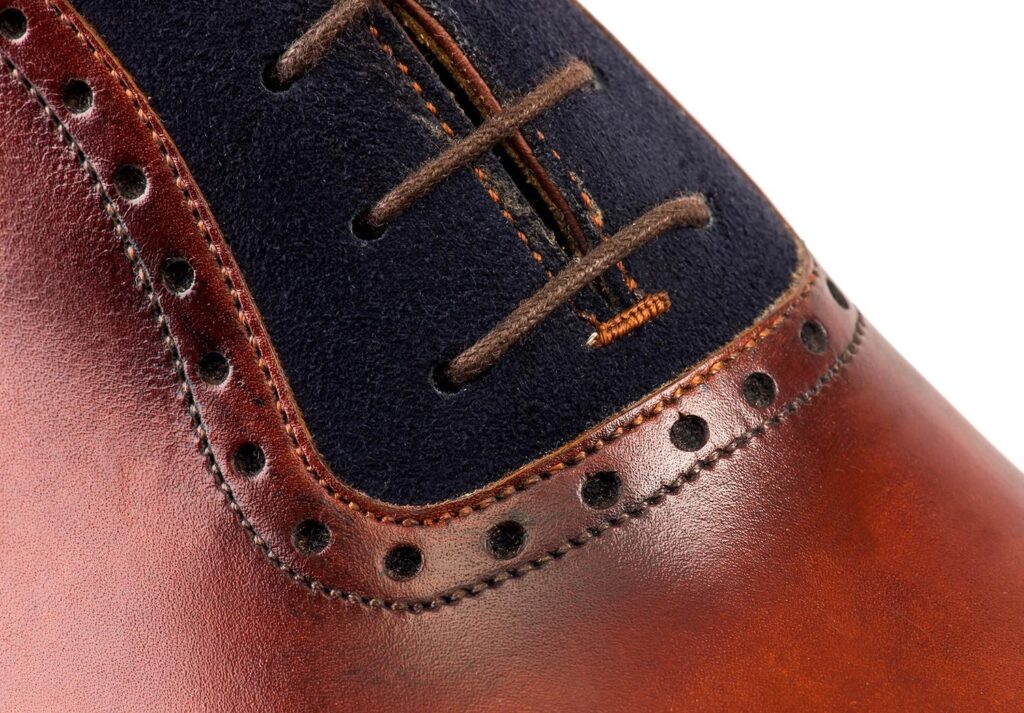 Close-up view of men’s gold-blue calf Italian Oxford shoe on K last with a single sole – handmade by Vass Shoes.