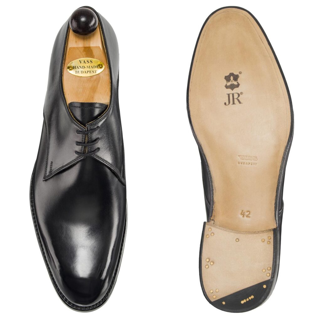 Angle view of men’s black London 3-eyelet Derby shoe on F last with a single sole – handmade by Vass Shoes.