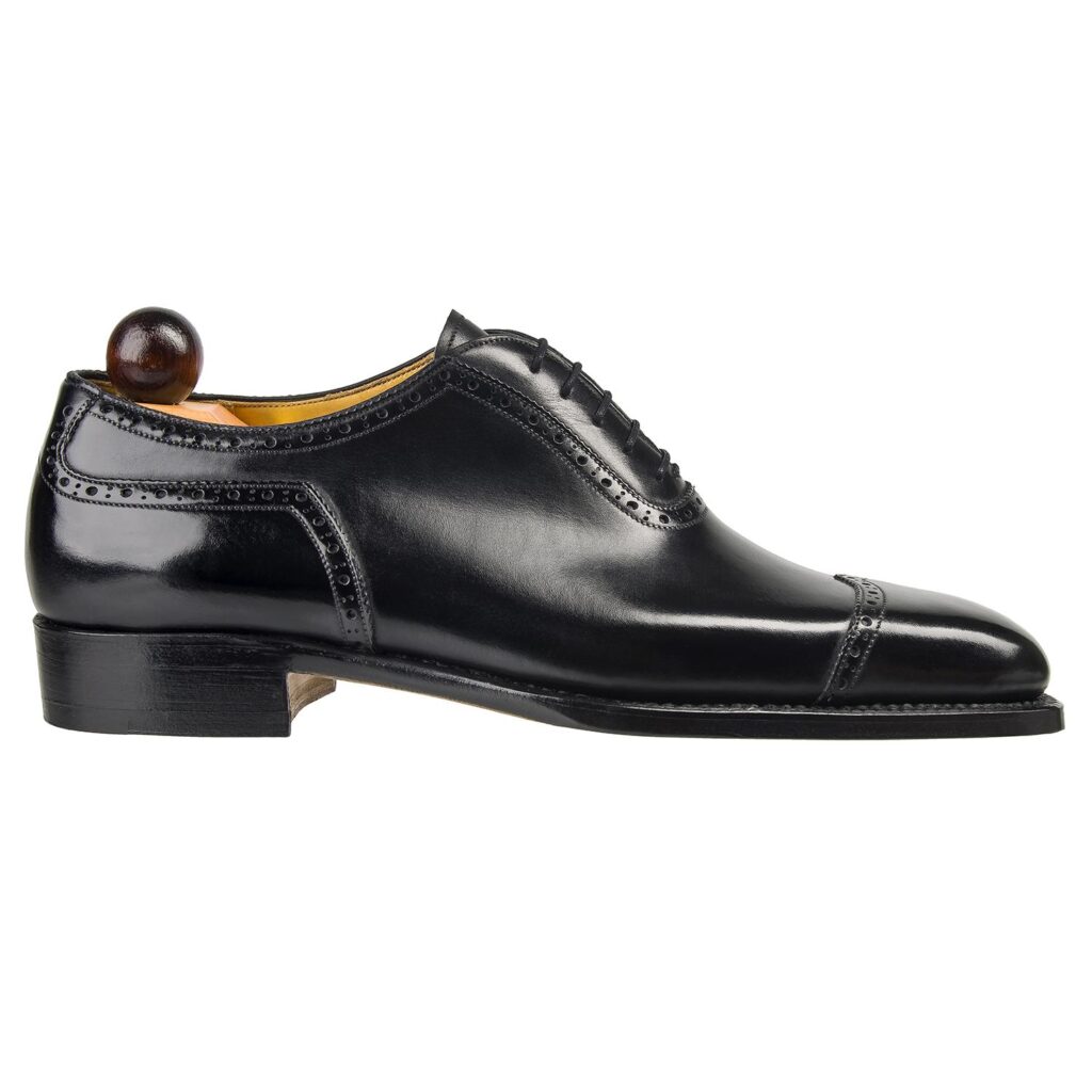 Side view-1 of men’s black V-cap Italian Oxford shoe on U last with a single sole – handmade by Vass Shoes.