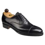 Angle view of men’s black calf leather cap toe Oxford shoe on P2 last with a single sole – handmade by Vass Shoes.