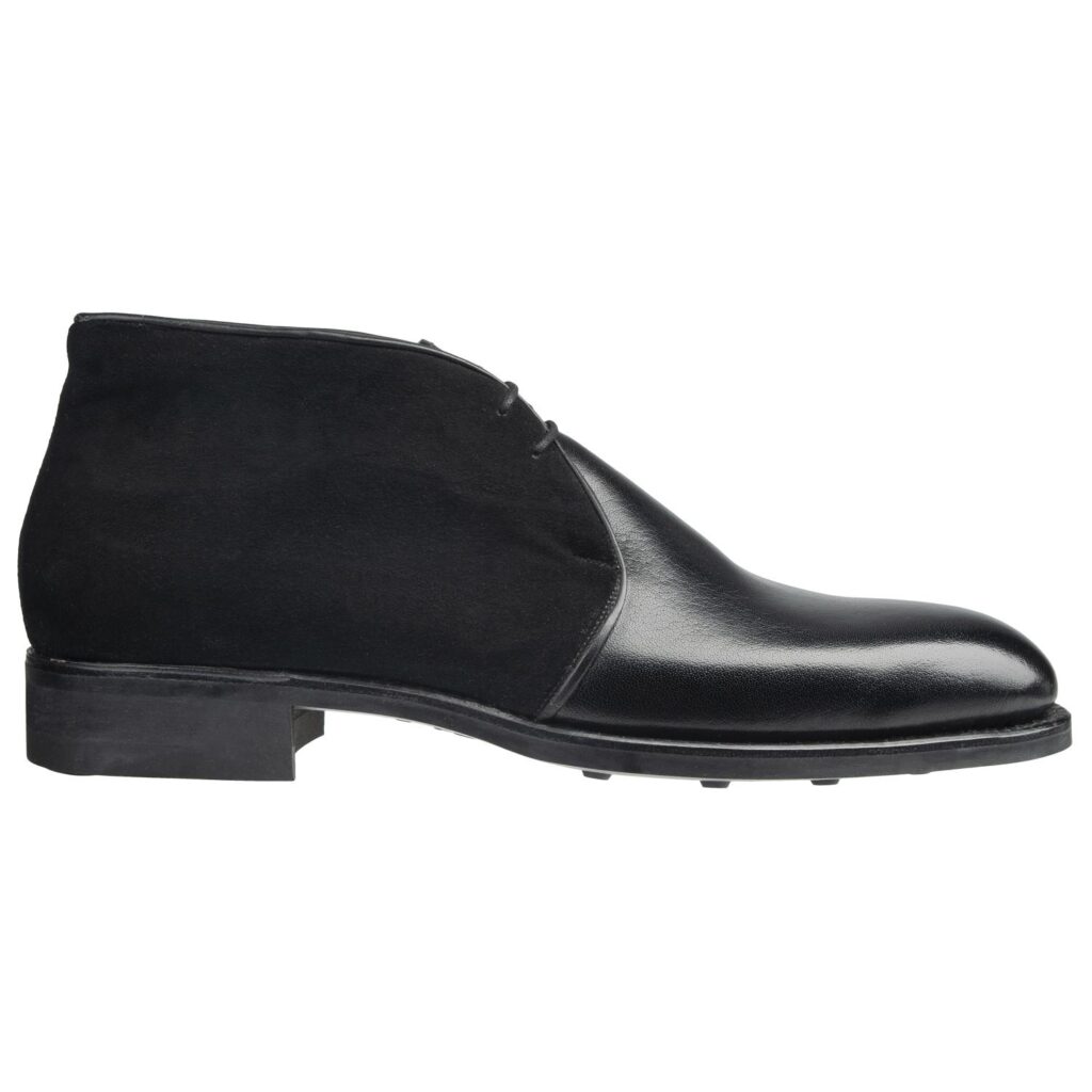 Side view-1 of men’s black 2-eyelet Chukka boots on F last with a dainite sole – handmade by Vass Shoes.