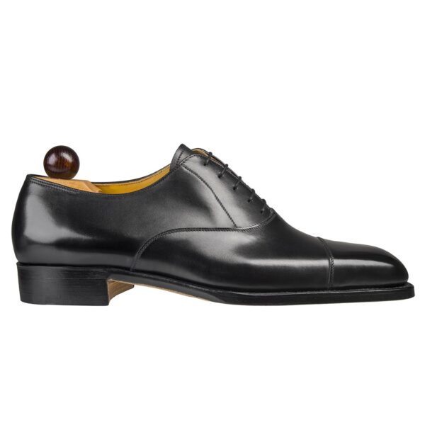 Side view-1 of men’s black calf leather cap toe Oxford shoe on U last with a single sole – handmade by Vass Shoes.