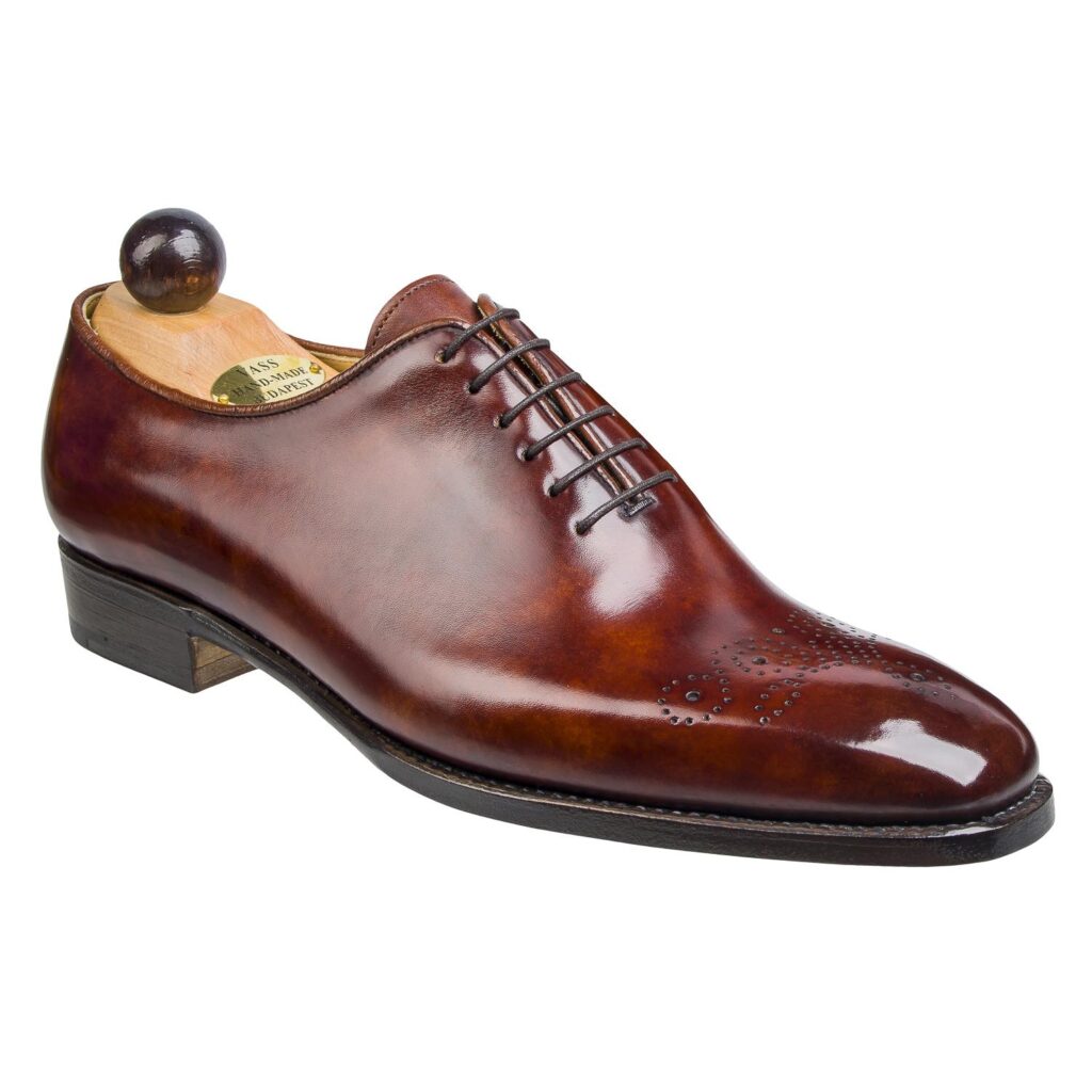 Angle view of men’s gold Wholecut 6-eyelets on S last with a single sole – handmade by Vass Shoes.