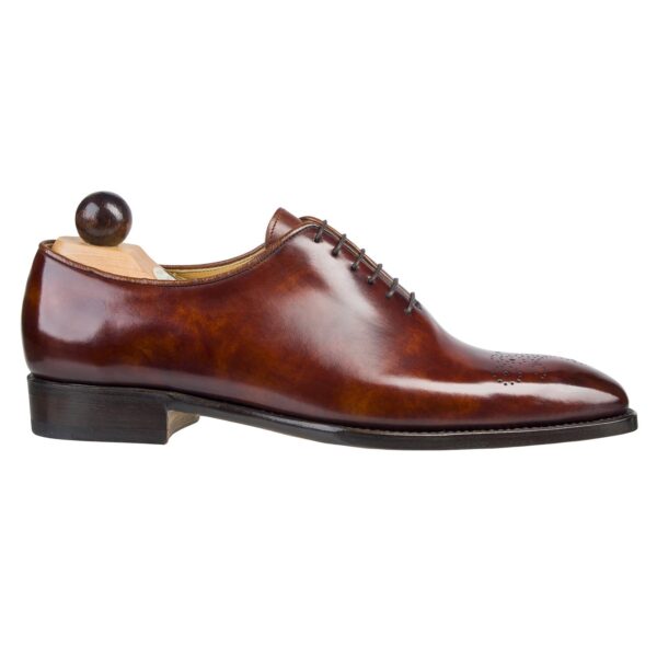 Side view-1 of men’s gold Wholecut 6-eyelets on S last with a single sole – handmade by Vass Shoes.