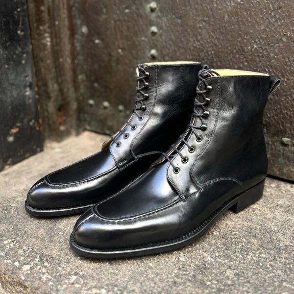 Angle view of men’s black calf Oslo high boots on F last with a dainite sole – handmade by Vass Shoes.