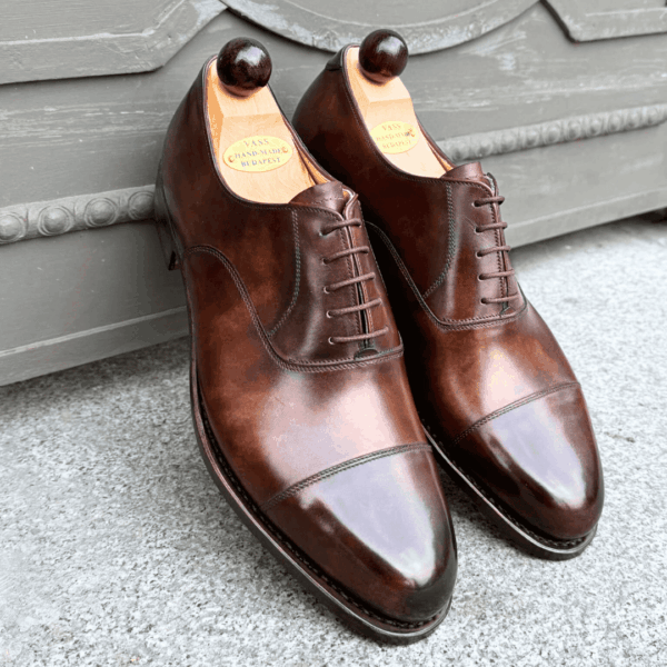 Angle view-1 of men’s walnut museum calf cap toe Oxford shoe on P2 last with a single sole – handmade by Vass Shoes.
