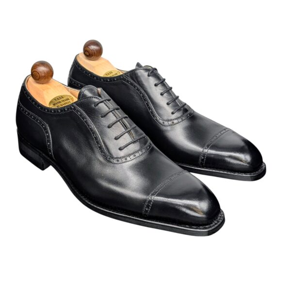 Angle view-1 of men’s black Italian Oxford round-heel-cap shoe on K last with a dainite sole – handmade by Vass Shoes.