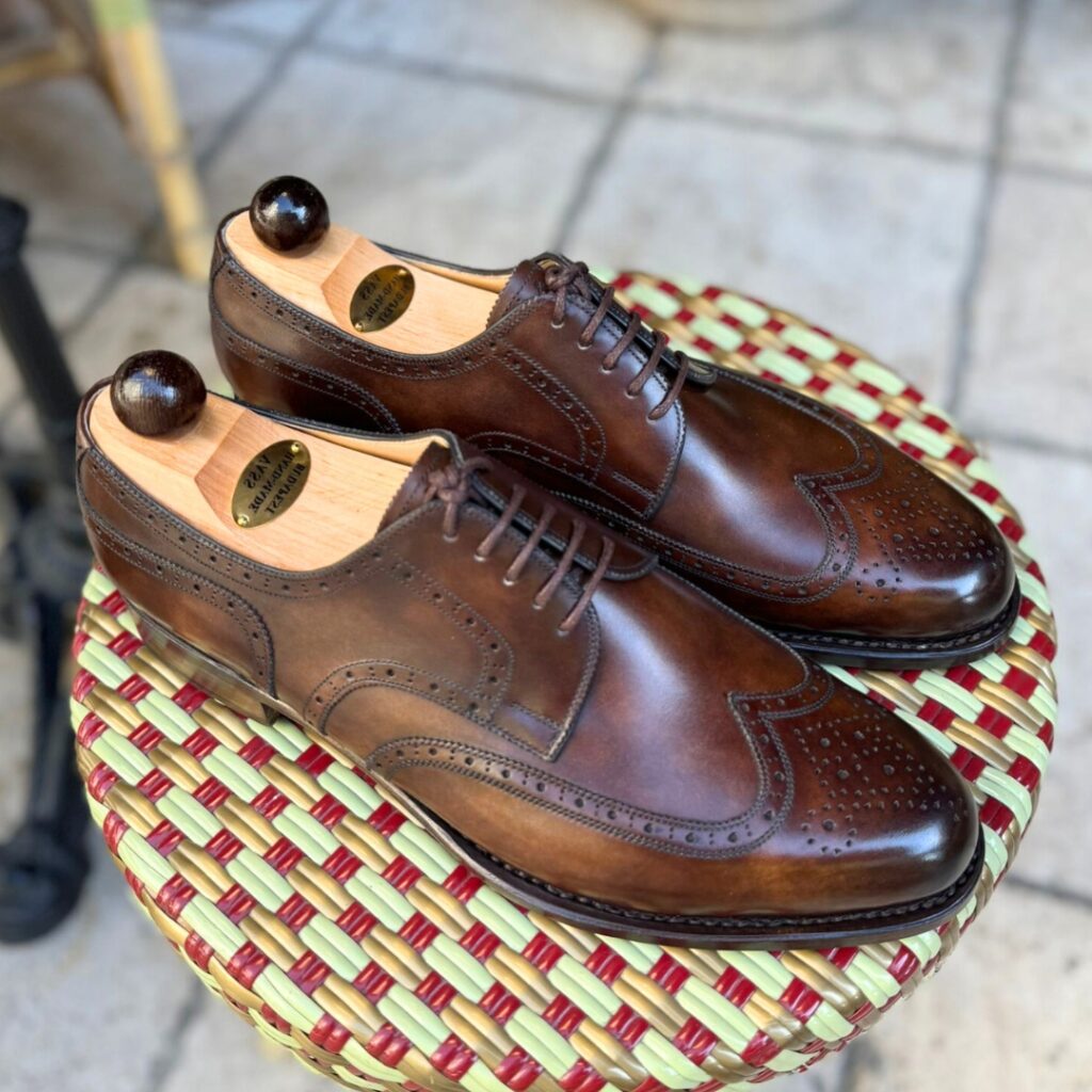 Angle view of men’s walnut museum calf Budapest Derby shoe on P2 last with a single leather sole – handmade by Vass Shoes.
