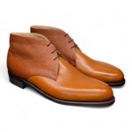 Angle view-1 of men’s cognac 3-eyelet Chukka boots on P2 last with a dainite sole – handmade by Vass Shoes.